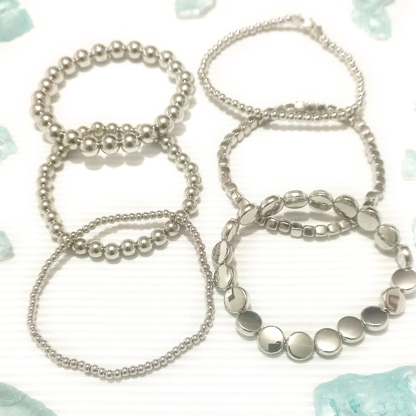 Juego de pulseras esfera plata